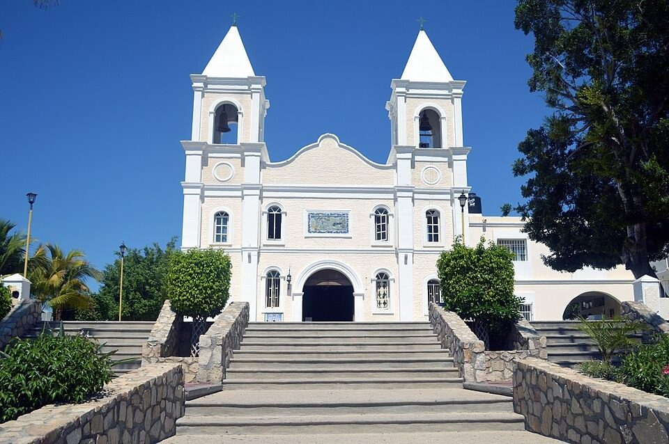 Stone stairway leading to the white facade of the San José del Cabo church on a sunny day